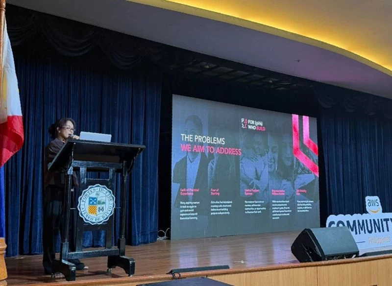FGWB PH presenting its mission on stage at AWS Community Day Davao